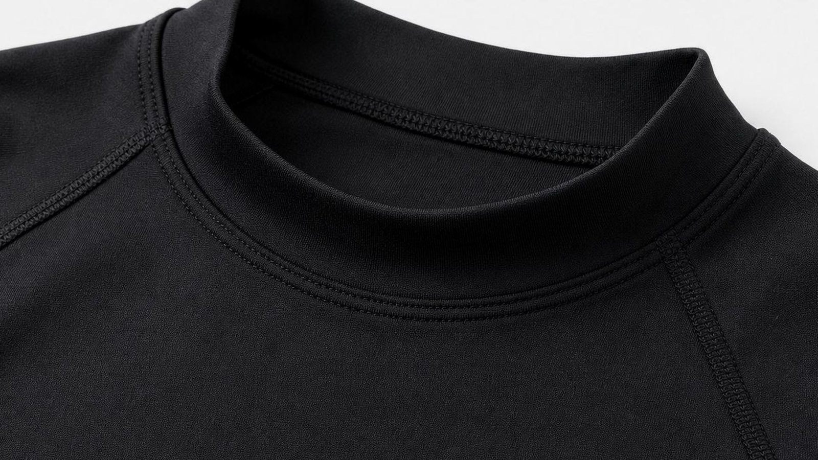 Collar stitching and coverstitch detail on a black base layer