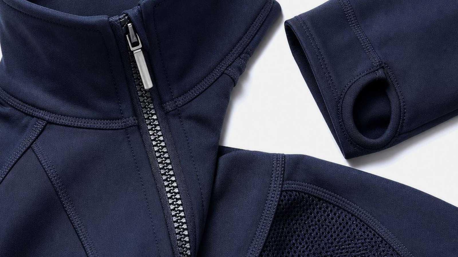 Finished zip placket and bonded mesh panel on a navy jacket